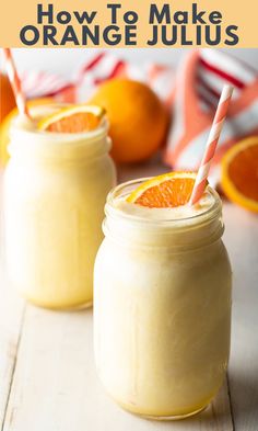 two mason jars filled with orange juice and topped with striped straws next to an orange slice