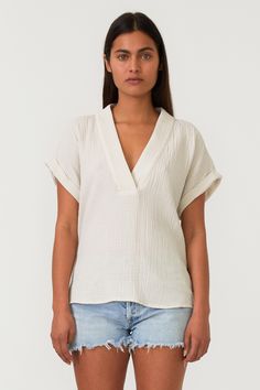 A relaxed fit top designed with a breathable cotton gauze fabric. Features a v-neckline and rolled up dolman sleeve. The perfect top for the Spring/Summer season. Affordable Boho, Cotton Gauze Fabric, Gauze Top, Weekend Activities, Simple Leather, Swimwear Sets, Gauze Fabric, Casual Tee, Cardigan Jacket