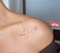 there is a tattoo on the chest of a man's left shoulder that reads 11