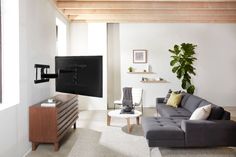 a living room filled with furniture and a large flat screen tv mounted on the wall