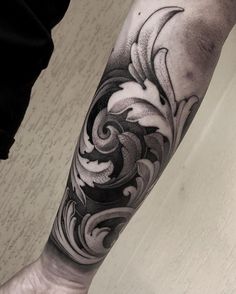 a man's arm with an artistic design on it