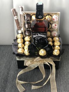 a bottle of booze and chocolates in a gift box