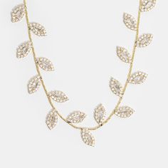 Add a touch of beauty to your everyday look with this elegant 14K Gold Plated Crystal Vine Necklace. Delicate and luxe, this necklace is perfect for any occasion. 14K gold plated AAA zirconia crystals Hypoallergenic, lead & nickel free If you aren't in LOVE with your purchase, please let us know within 30 days of receiving your item, and you'll receive a stress-free refund. Elegant Gold Crystal Rhinestone Necklace, Gold Cubic Zirconia Necklace For Party, Dazzling Gold Rhinestone Necklace For Formal Occasions, Elegant Yellow Gold Necklace With Rhinestones, Gold Crystal Rhinestone Necklace For Anniversary, Elegant Gold Rhinestone Necklace With Sparkling Stones, Adjustable Sparkling Gold Necklace, Gold Rhinestone Necklace With Sparkling Stones, Gold Rhinestone Necklace For Wedding With Clavicle Chain