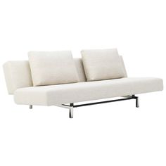 a white couch sitting on top of a metal frame