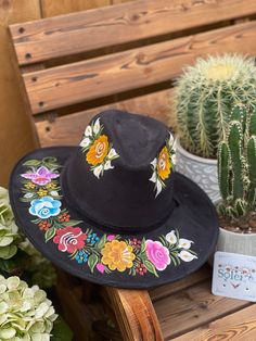 This Mexican Suede Hat is perfect to add that special touch to any outfit. This Mexican Hat is completely hand painted and one of a kind! This structured suede hat has a high crown and a teardrop top. The wide brim is accented by a band and colorful painted flowers. The hat is made in Mexico by artisanal hands made with love for you to look gorgeous and fashionable. Custom Hand Painted Hat Bands For Festivals, Artisan Hand Painted Fedora For Festivals, Artisan Hand-painted Fedora For Festivals, Artisan Hand Painted Hat Bands With Flat Brim, Handmade Artistic Hat For Festivals, Multicolor Hand Painted Hat With Curved Brim, Artistic Handmade Hat For Festivals, Hand Painted Fedora Hat Bands For Festivals, Hand Painted Brimmed Festival Hats