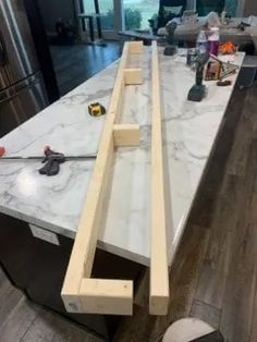 a kitchen counter is being constructed with white marble