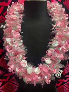 a pink and white necklace on a mannequin