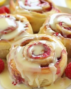 raspberry cinnamon rolls with icing on a plate