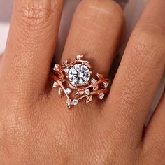 a woman's hand with a rose shaped diamond ring on top of her finger