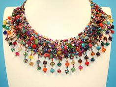 "This stunning, elegant colorful necklace was hand beaded by one of our group of Mayan women in the village of Santiago Atitlan, Guatemala. It is full of Czech beads and natural stones that make a beautiful fashion statement. Each necklace is individually handmade; therefore there may be a slight variance in the placement and color of the natural stones and beads. 18\" tip to tip Toggle closure with 3 adjustable loop" Bohemian Rainbow Crystal Necklaces With Colorful Beads, Bohemian Rainbow Crystal Necklace With Colorful Beads, Multicolor Beaded Bohemian Crystal Necklaces, Artisan Multicolor Beaded Crystal Necklace, Bohemian Rainbow Beads For Jewelry Making, Rainbow Bohemian Beads For Jewelry Making, Bohemian Rainbow Gemstone Beads Necklace, Bohemian Multicolor Beaded Crystal Necklaces, Bohemian Rainbow Beaded Jewelry