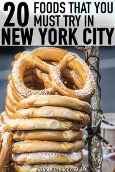 a stack of pretzels sitting on top of a table with the words 20 foods that you must try in new york city