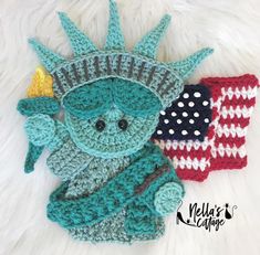 a crocheted statue of liberty and an american flag