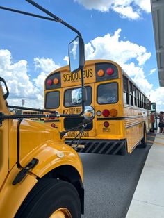 two yellow school buses parked next to each other