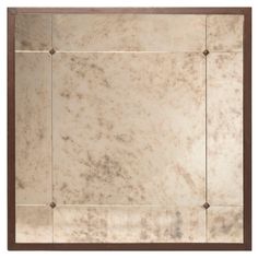 a white marble wall with brown trim around the edges and square holes in the middle