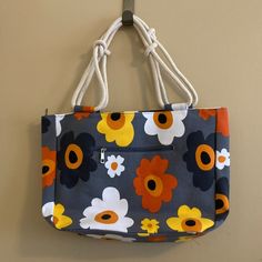 Cute Dark Gray Canvas Bag With Bright Flowers. Material Is Durable Canvas Like The One Used In Maine. Thick Sailor-Knotted Double Straps. Zippered Pocket In Front. Open Pocket And Zippered Pocket Inside. Whole Bag Zips Up. Measures 18" Wide X 12" Long X 5" Deep. Bag Was Featured In Paramount Tv Show "The Good Fight." Farmhouse Is My Style Summer Bloom. Nwt. Never Used. Yellow Canvas Bag For Spring Travel, Spring Yellow Canvas Bags, Yellow Canvas Bag For Everyday Spring Use, Spring Yellow Canvas Bag For Everyday Use, Spring Yellow Canvas Bag For Daily Use, Spring Yellow Canvas Bag For Everyday, Yellow Flower-shaped Spring Bag, Spring Yellow Flower-shaped Bag, Yellow Floral Print Travel Bag