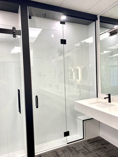 a bathroom with a sink, mirror and shower stall