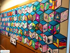 an art work is displayed on the wall in front of a group of children's artwork