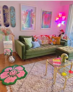 a living room filled with lots of furniture and colorful art on the wall above it