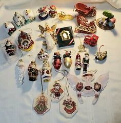 a collection of christmas ornaments on a bed