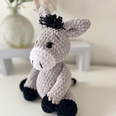 a crocheted stuffed animal sitting on top of a table