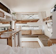 the interior of a camper is clean and ready to be used as a kitchen