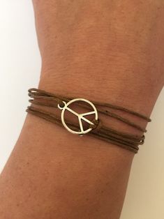 "BUY TWO GET A THIRD FOR FREE!! (please, don't add your free product to your shopping cart or you will be charged for it. Pick 1 product and leave the full name of it in the \"Note to enjoywelrydesign\" Box during checkout.)This is a waxed cotton Karma peace bracelet with a metal ring charm. What goes around, comes around. Wear your bracelet as a reminder, to keep the circle positive, peaceful and loving. The bracelet is adjustable and fits wrists from 51/2'' to 81/2\" (14cm to 22cm). The width Adjustable Waxed Cord Bracelets, Casual Waxed Cord Jewelry, Adjustable Wrap Bracelet For Friendship In Summer, Brown Bracelets, Summer Gift, Brown Bracelets As Summer Gifts, Brown Bracelet As Summer Gift, Brown Summer Bracelets As Gift, Trendy Adjustable Wrap Bracelet For Festival, Brown Summer Bracelets As Gifts