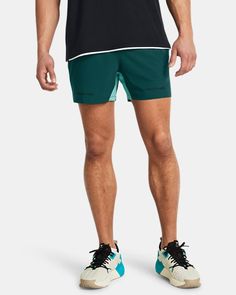 a man in black shirt and green shorts