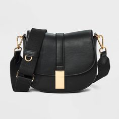 This Saddle Crossbody Bag from A New Day™ with a structured silhouette features a roomy main compartment and an interior zip pocket for easy organization of your belongings, plus an overlapping flap with a gold-tone buckle accent and magnetic closure. Plus, the detachable adjustable shoulder strap makes carrying a breeze whether you sling it over one shoulder or carry it in hand. A New Day™: Style that goes wherever you do. Target Purse, Saddle Crossbody Bag, Cute Crossbody Bags, Black Crossbody Purse, Top Handle Handbags, Crossbody Messenger Bag, Black Crossbody, Small Purse, Black Cross Body Bag