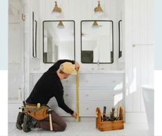 a man is measuring the wall in his bathroom