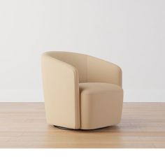 a beige chair sitting on top of a wooden floor