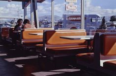 two people sitting at a table in a restaurant