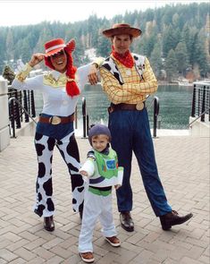 three people dressed up as toy story characters and one is holding the hand of a child