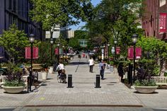 people walking and biking on a city street