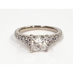 a princess cut diamond ring with pave set shoulders