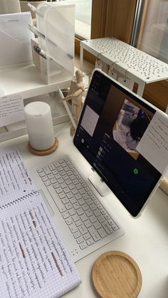 an open laptop computer sitting on top of a white desk