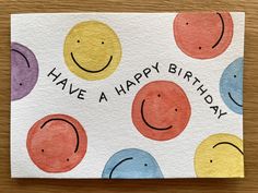 a happy birthday card with smiley faces on it