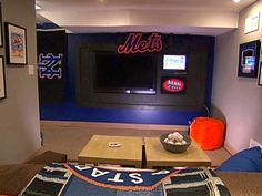 a living room with a couch, television and baseball jersey on the table in front of it