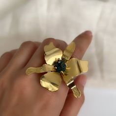 Ring large orchid flower, Perfect for gift giving this ring with natural stone, gold plated ring, perfect large size that will not go unnoticed, Ring band ajutable. Unique ring made 100% handmade in bronze with 24 carat gold plating. This orchid flower ring has a stone in the center called chalcopyrite. ►Buy together with orchid flower earrings and get free shipping, this link takes you to chalcopyrite orchid flower earrings: https://sanpaojewelry.etsy.com/listing/1616204470 ►MEANING OF THE JEWEL ♥The stone in the center is called chalcopyrite and has a very nice meaning: it connects you to higher realms. It has a positive vibration and increases happiness, joy and self-confidence. And like most GOLD stones, it is a stone of abundance. ►PRODUCT DETAILS *Handmade article *Length: 1.7 Inches Adjustable Flower Crystal Ring Gift, Adjustable Flower Crystal Ring For Gift, Adjustable Gold Flower Ring, Gold Flower-shaped Rings With Gemstones, Handmade Gold Ring With Flower Shape, Gold Plated Flower Ring As Gift, Unique Gold Flower Ring Gift, Unique Gold Flower Ring As Gift, Gold Flower Open Ring For Gift