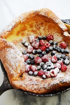 powdered sugar and berries in a skillet