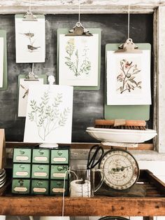 an old desk with pictures and other items on it, including a clock hanging from the wall