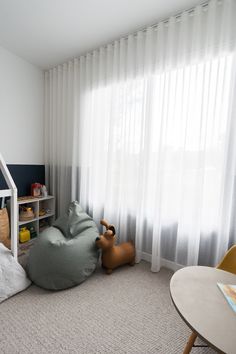 a child's bedroom with a loft bed and play area in the corner,