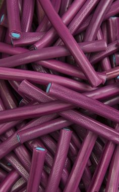 purple sticks are stacked together in a pile