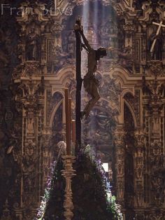 the crucifix is displayed in front of an ornate wall with purple flowers