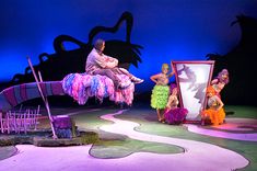 the stage is set for an upcoming show, with performers dressed in colorful costumes and fringes