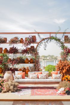 an outdoor seating area with flowers and potted plants