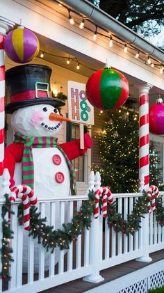 christmas decorations on the front porch of a house with snowman and candy canes