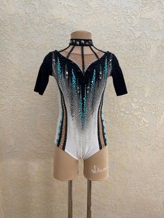 a woman's leotard with sequins and beads on the back