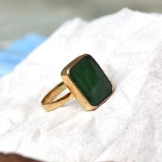 Yellow Gold Rings With Rectangular Gemstone, Rectangular Gold Emerald Ring, Gold Emerald Ring With Rectangular Stone, Yellow Gold Rings With Natural Stones For Gift, Yellow Gold 14k Rings With Natural Stones, Yellow Gold Emerald Ring With Rectangular Stone For Gift, Elegant Untreated Emerald Ring For Anniversary, Elegant Gold Emerald Ring With Natural Stones, Gold Emerald Ring Untreated For Gift