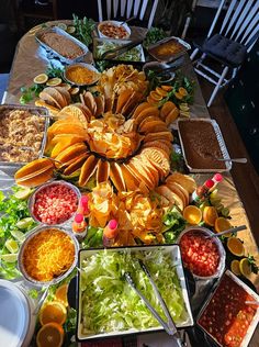 a table filled with lots of different types of food on top of plates and bowls