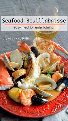 seafood is served on a red plate next to a glass of wine with the caption seafood boillabaise easy meal for entertaining